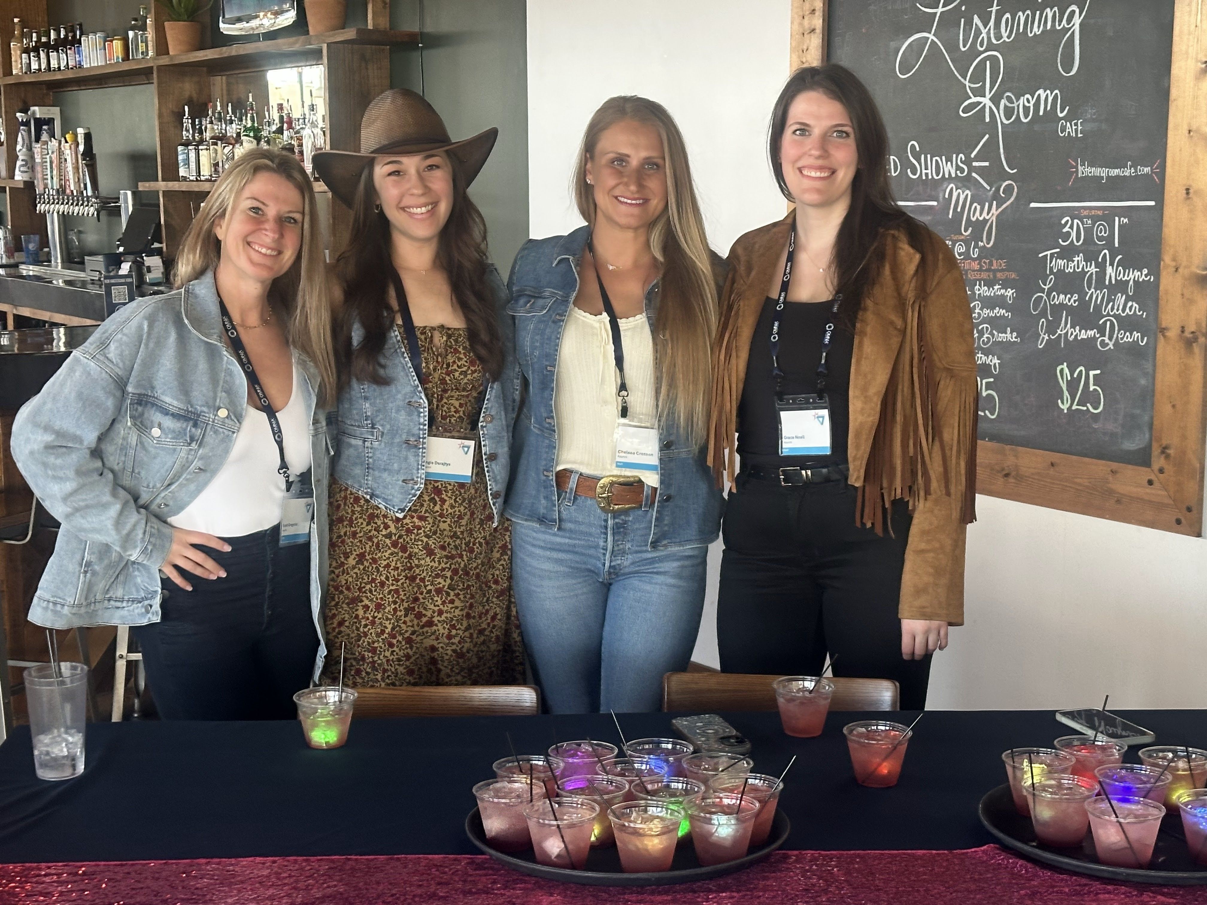 Four Asurint team members at a social gathering in the company’s photo gallery