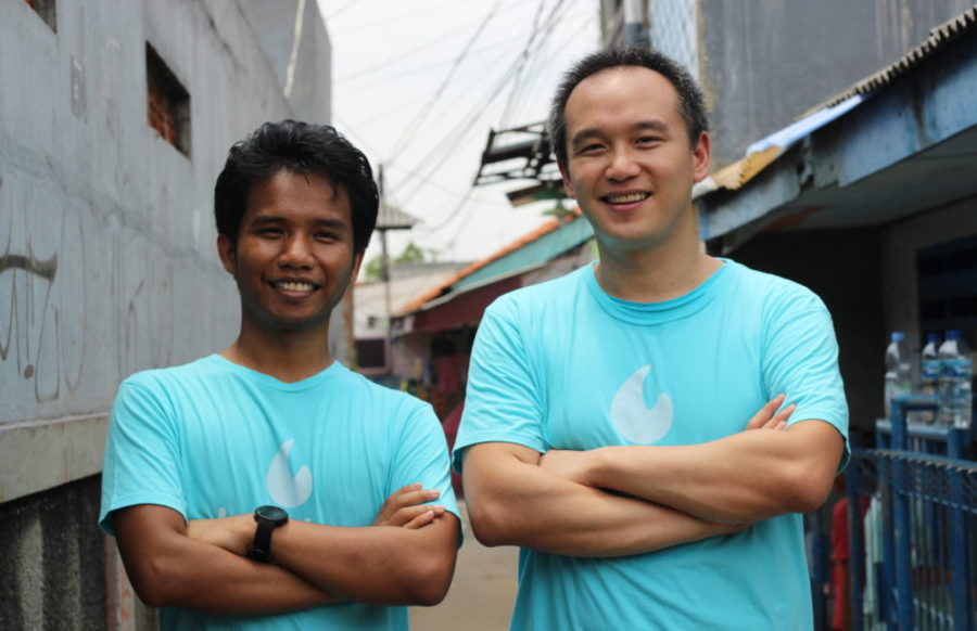 Lumina co-founders Tri Ahmad Irfan and Aswin Andrison standing outdoors in matching turquoise shirts