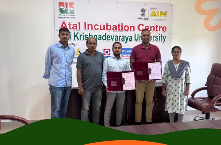 Representatives holding agreement documents at AIC-SKU, in a photograph published by Ambigo