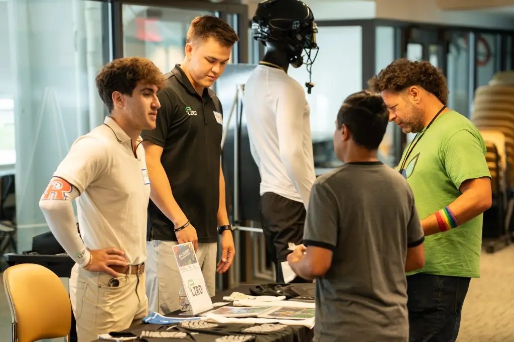 Four participants talking around an LZRD table at an ATDC networking event
