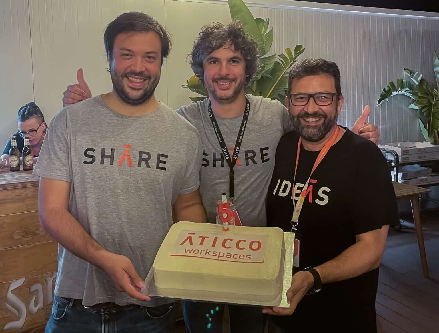Aticco’s three co-founders celebrating the company’s fifth anniversary with a branded cake