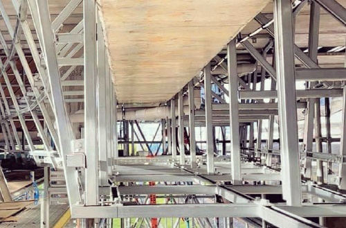 An array of metal support frames beneath a construction platform