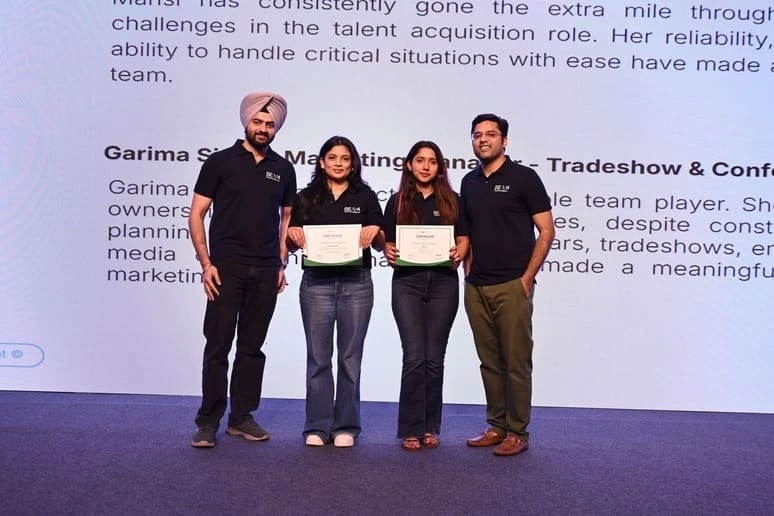 Attentive.ai team members holding certificates at an employee recognition event