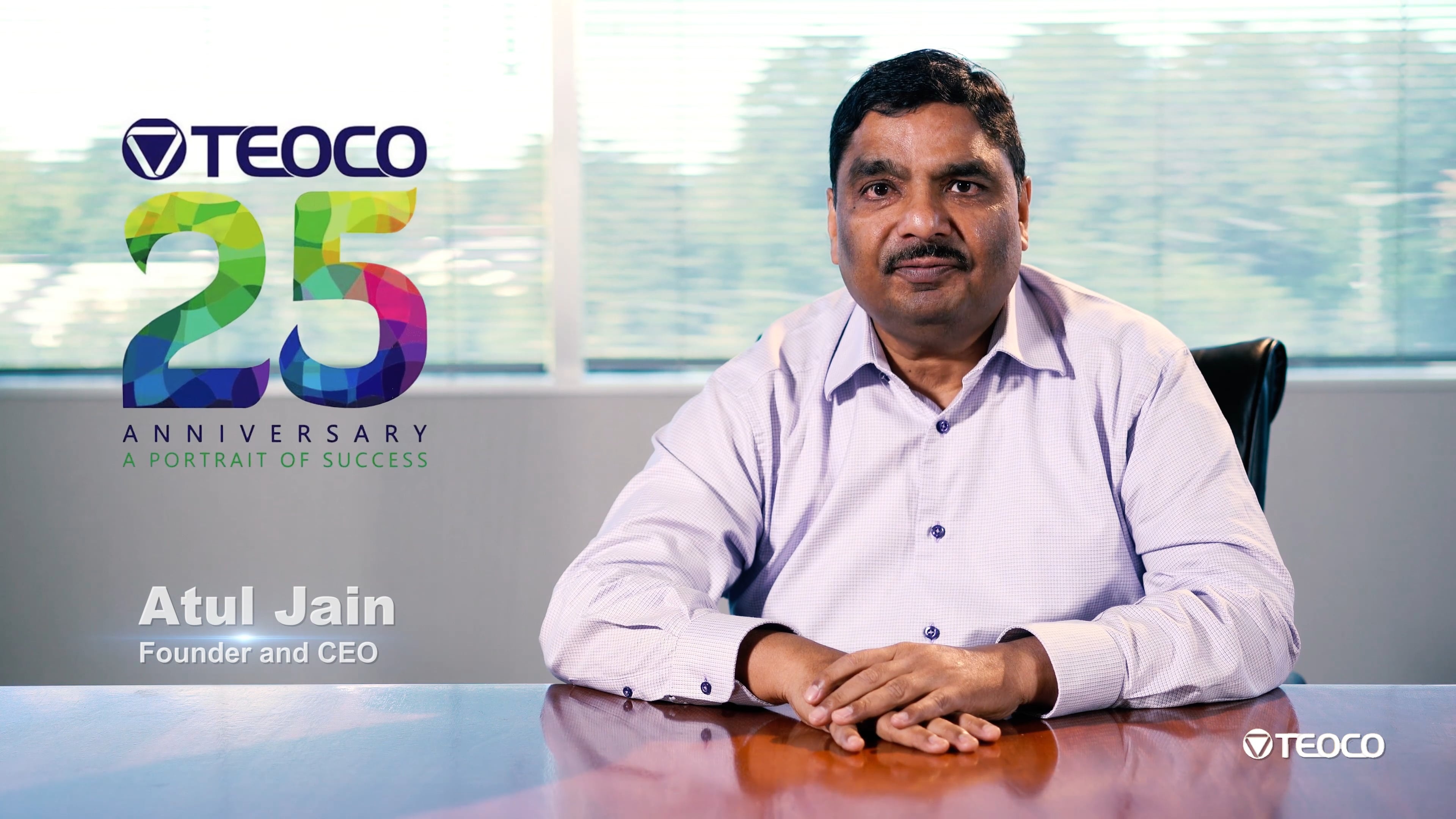 Atul Jain seated at a conference table during TEOCO’s twenty-fifth anniversary interview
