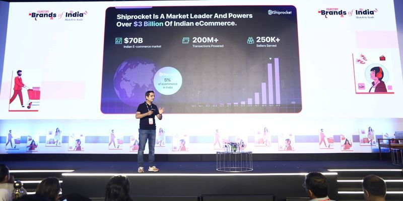 Atul Mehta speaking on stage at Brands of India 2024, with a Shiprocket presentation behind him
