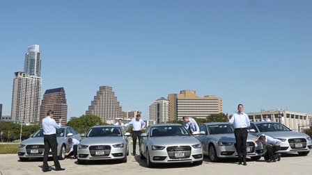 Early Silvercar team standing with silver Audi vehicles