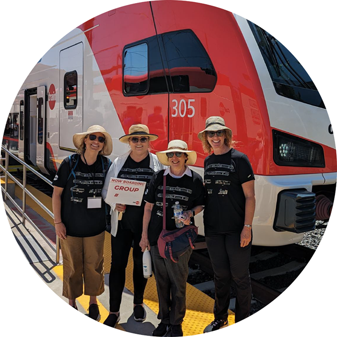 Circlepoint staff standing in front of a Caltrain train at an outreach event