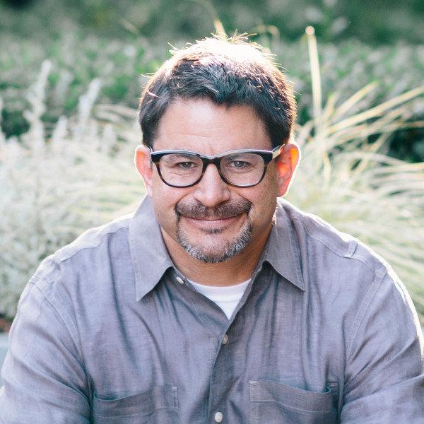 August Capital investor David Hornik wearing glasses and a gray shirt outdoors