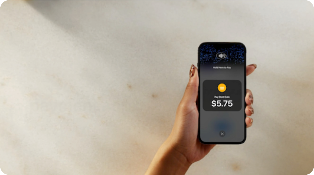 Aurus promotional image showing contactless payment acceptance on an iPhone