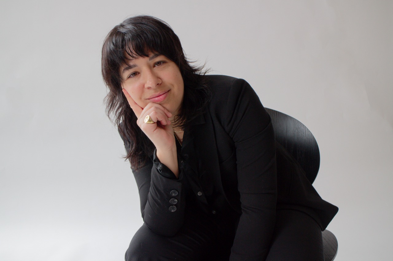 AUSTERE founder Natasha Brito seated against a pale studio background