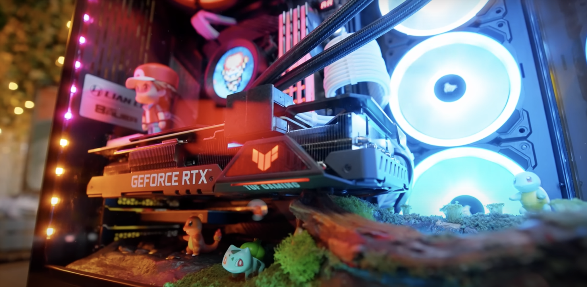A colorful Pokémon themed gaming PC with character figures around its components