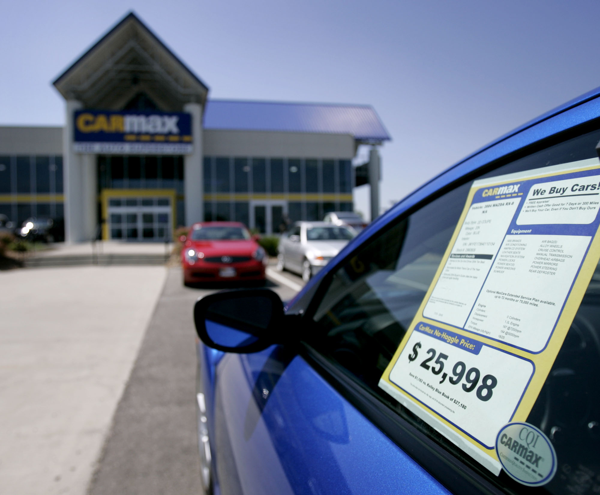 A vehicle window sticker in front of a CarMax store in 2005