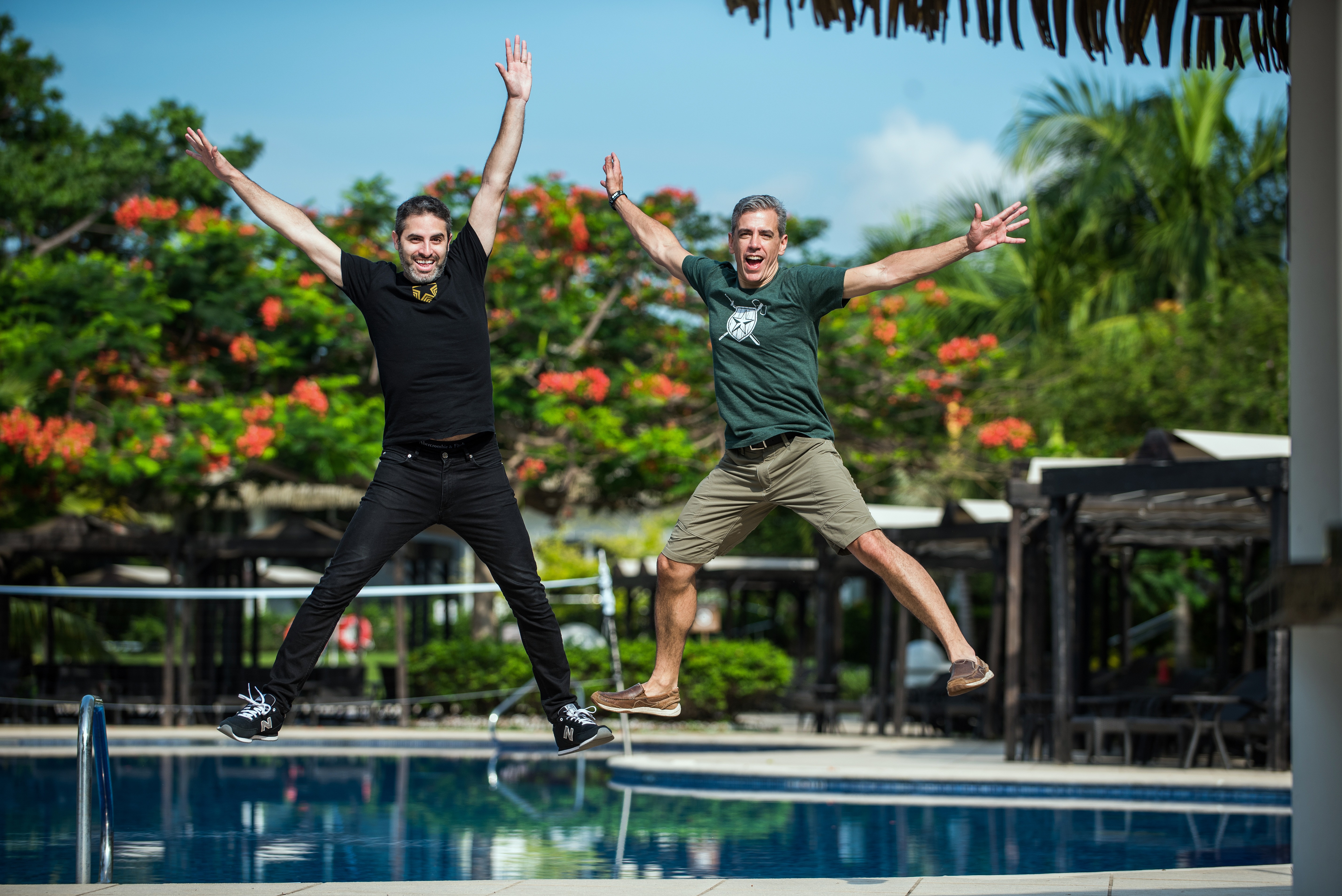 Auth0 co-founders Matias Woloski, left, and Eugenio Pace, right, jump beside a pool
