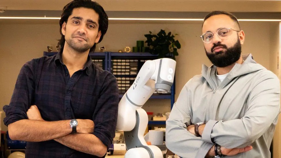 Suryansh Chandra and Mostafa ElSayed beside the Eva robotic arm