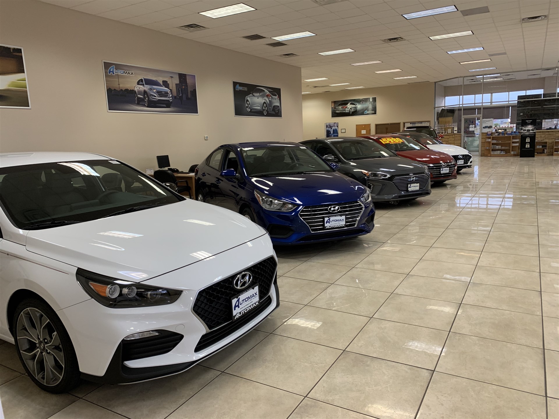 Automax-branded Hyundai showroom with vehicles on a tiled sales floor