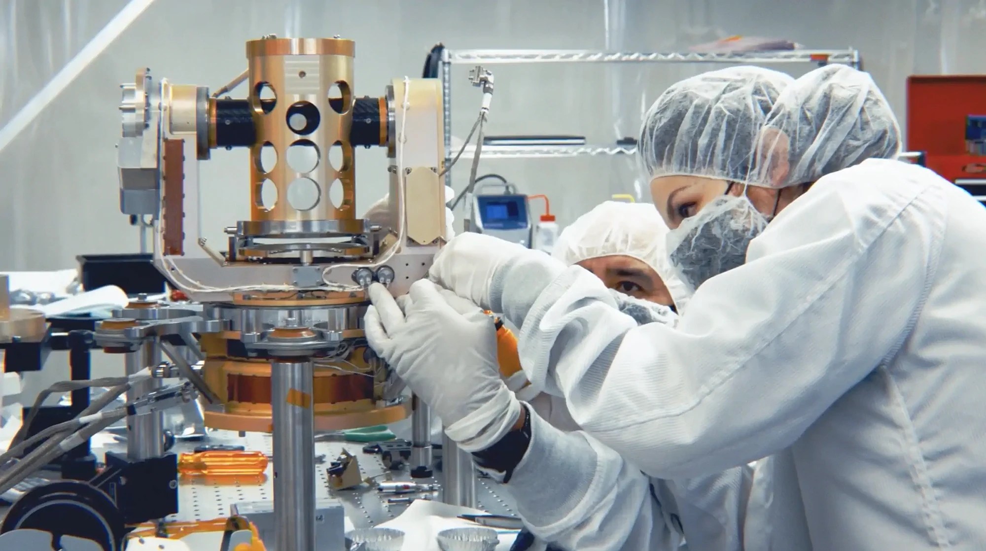 AV cleanroom personnel working closely on precision hardware