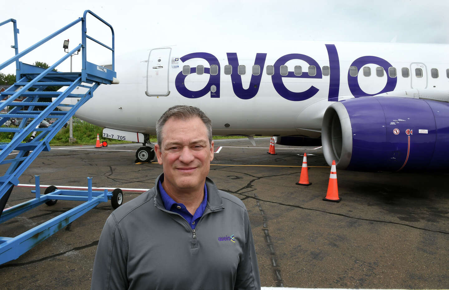 Founder Andrew Levy beside an Avelo aircraft at Tweed New Haven
