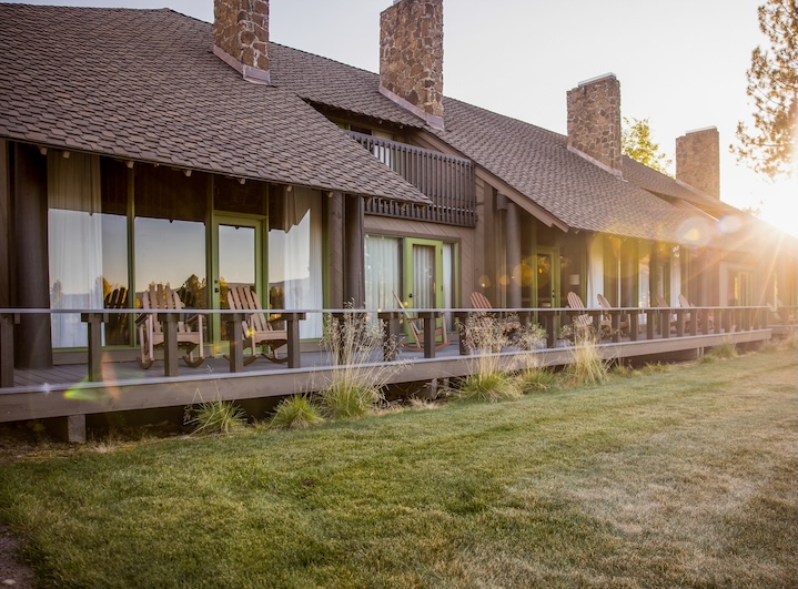 Sunriver Resort lodge with stone chimneys and Adirondack chairs in evening sunlight