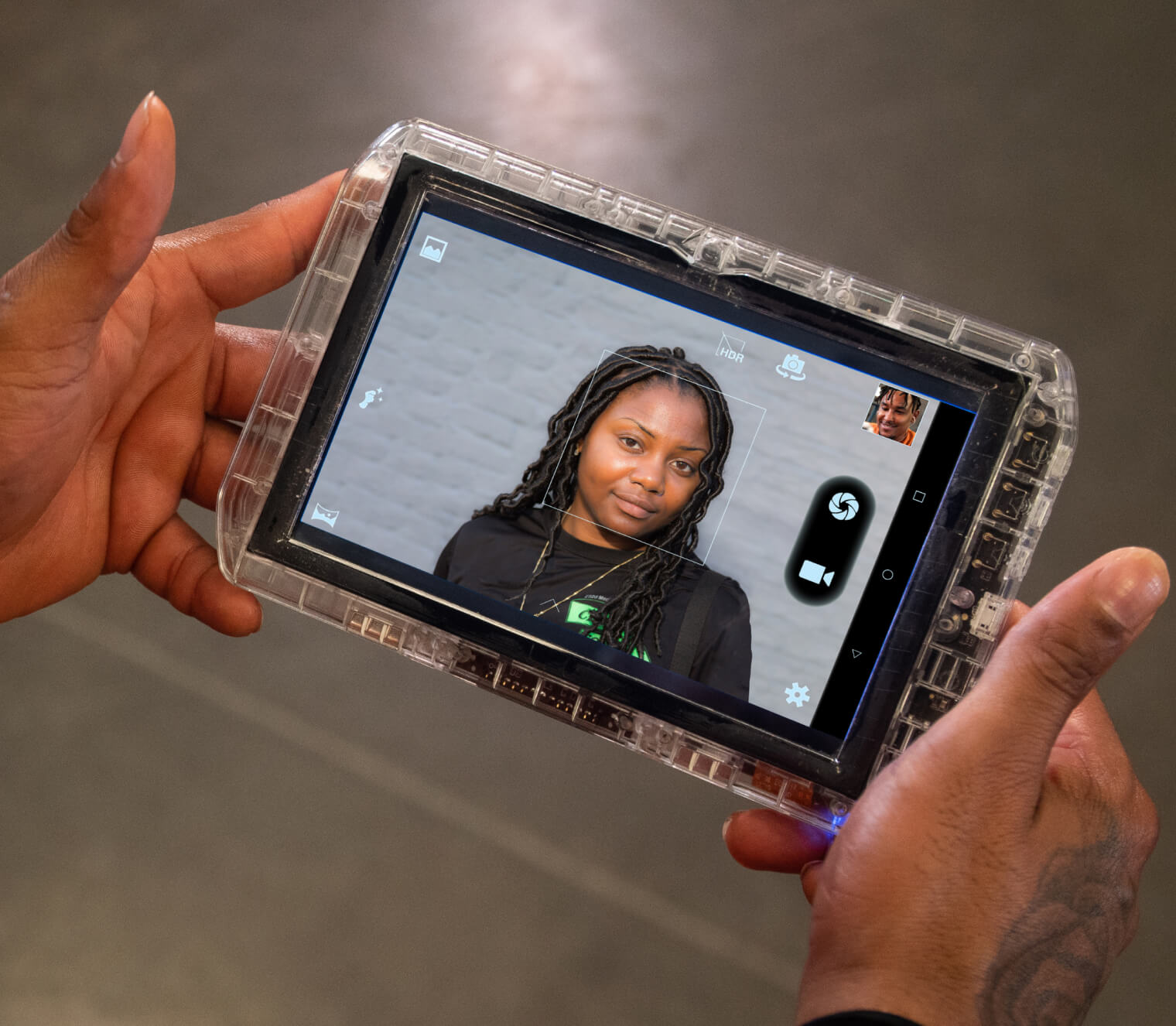 Official Securus marketing image of hands holding a clear-cased tablet displaying a video connection