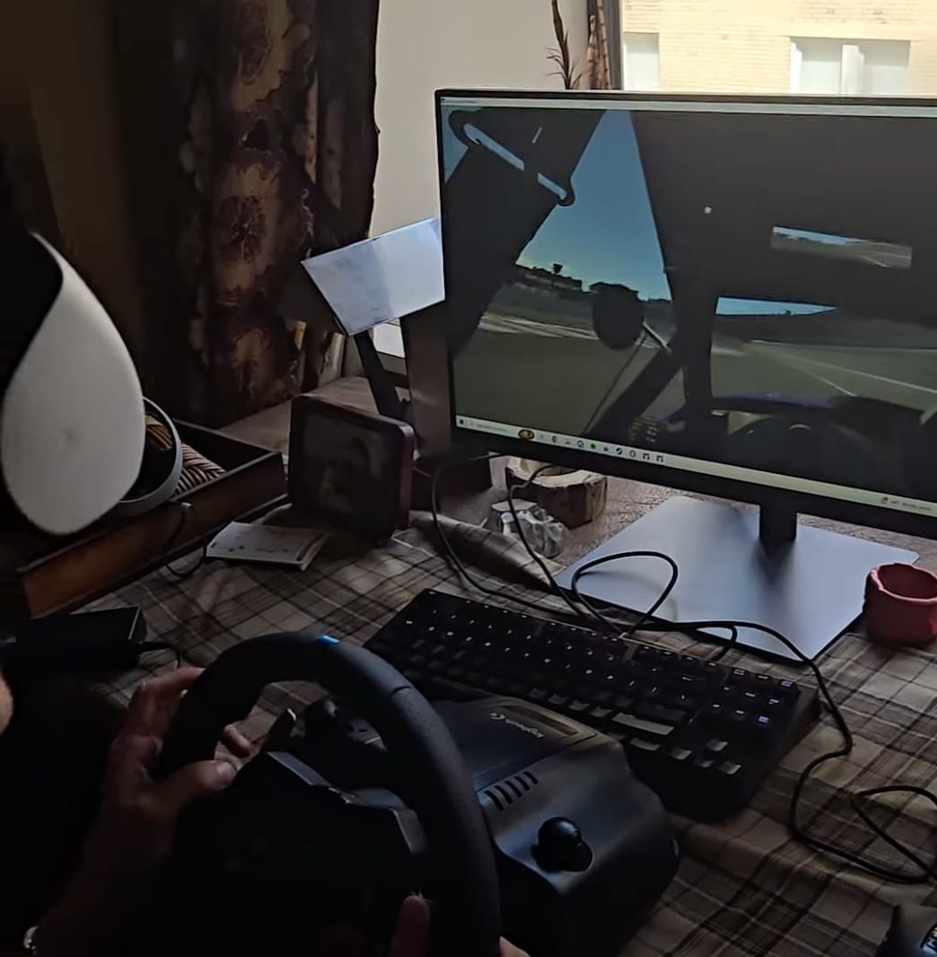 A steering wheel and monitor in Durrant's home racing simulator setup