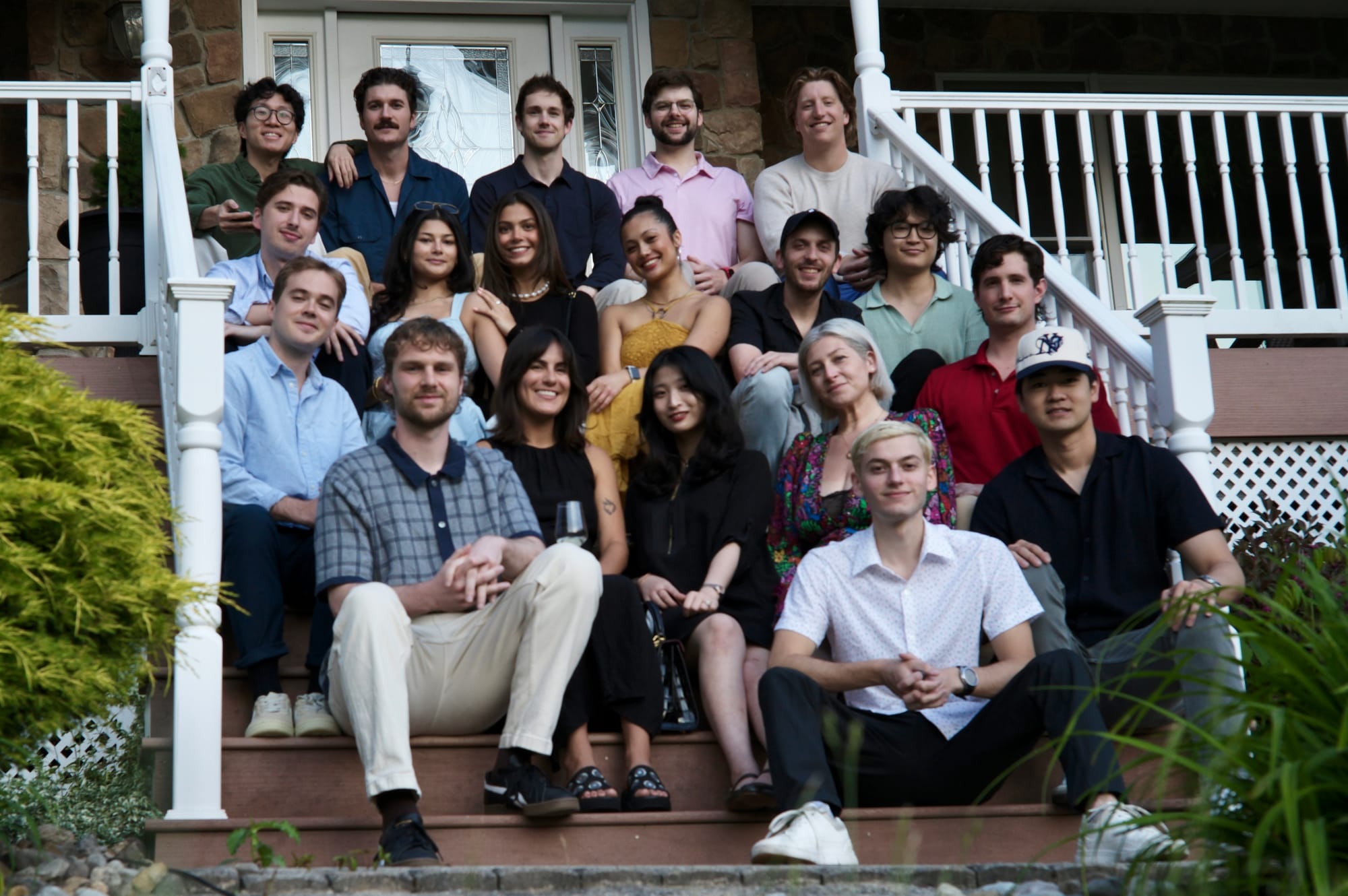 The Dripos team gathered on the steps of a house at their 2024 off-site