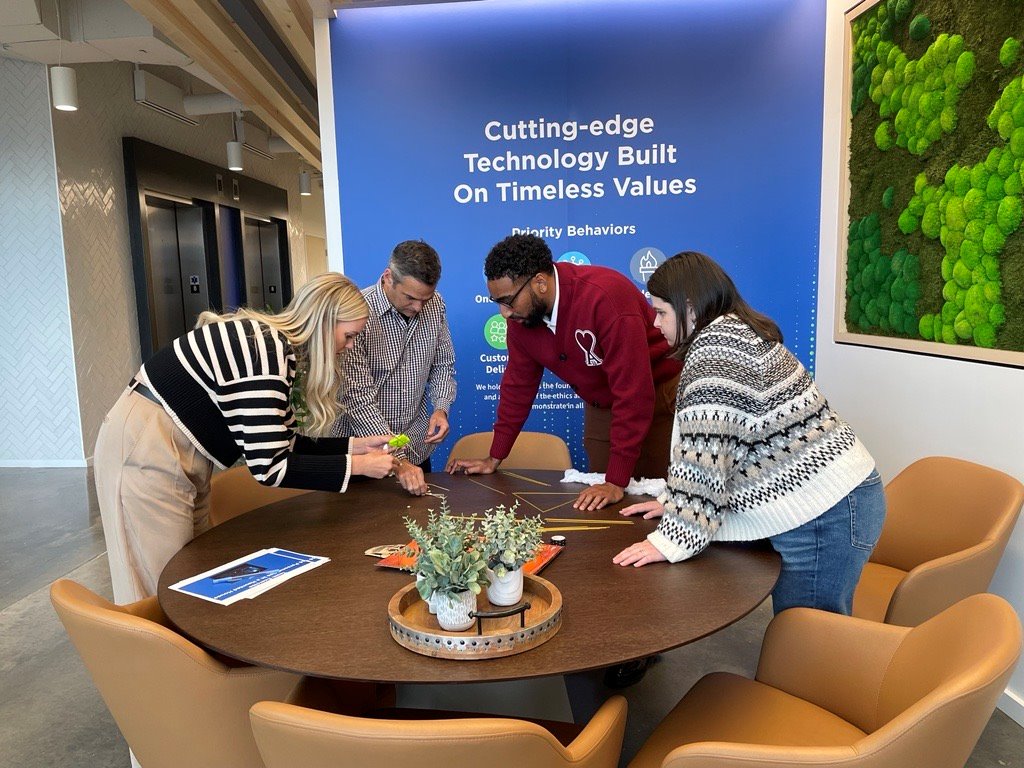 Avetta employees collaborating around a table in the Lehi office