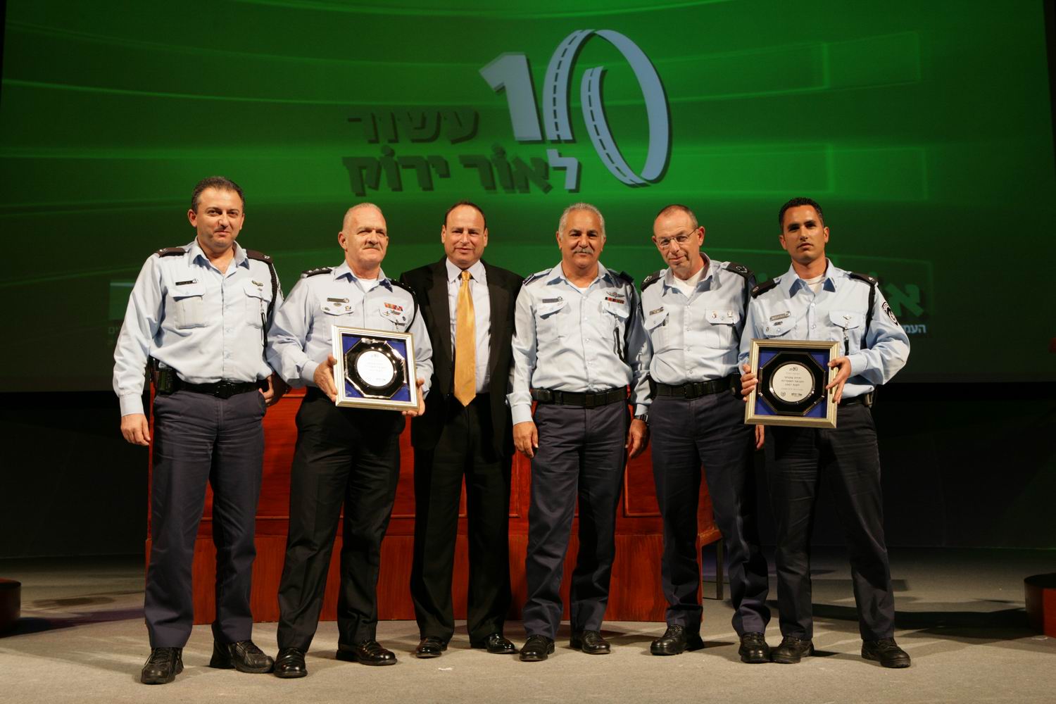 Avi Naor, third from left, standing with police officers at an Or Yarok event