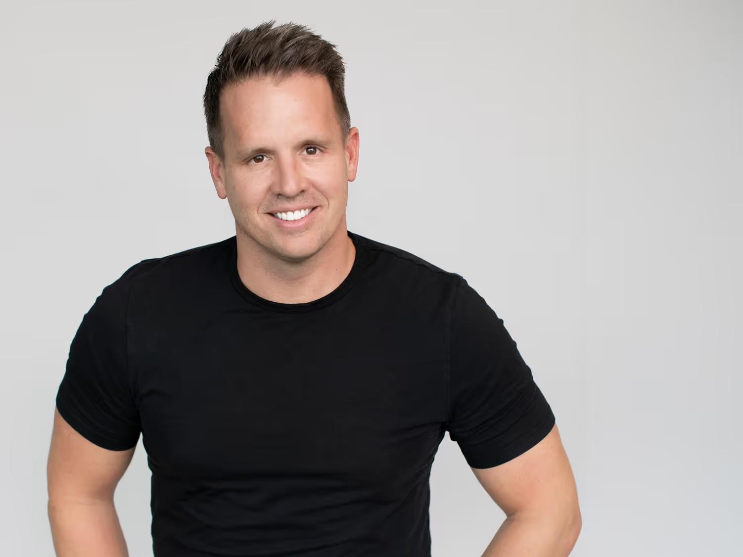 Awardco co-founder and CEO Steve Sonnenberg smiling in a black shirt