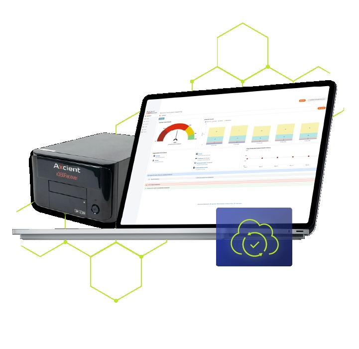 Axcient x360Recover backup appliance beside a laptop showing its management dashboard