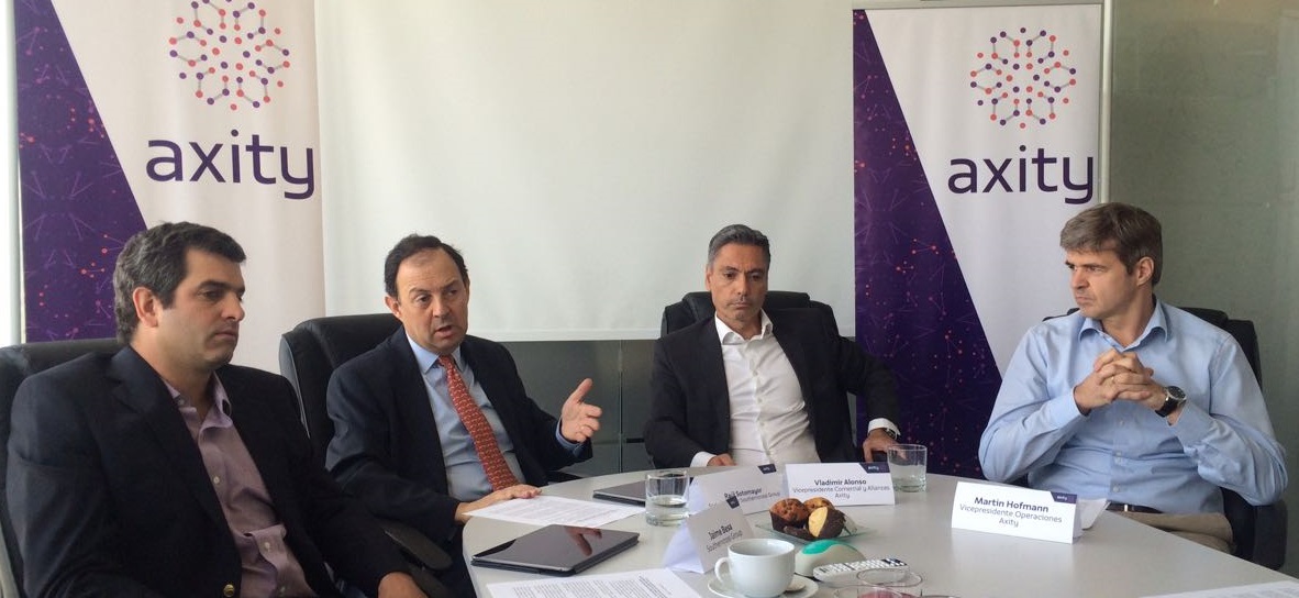 Axity executives seated around a meeting table at the company’s 2017 presentation