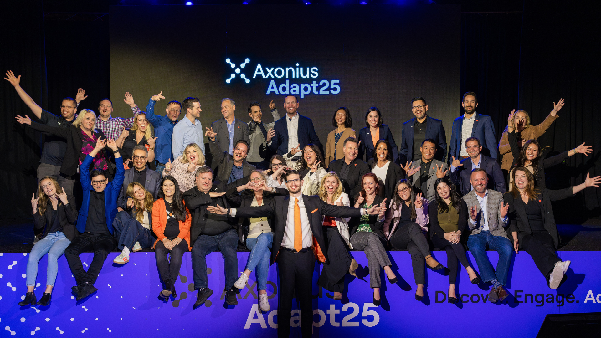 Axonius employees and partners gathered on stage at the Adapt25 event