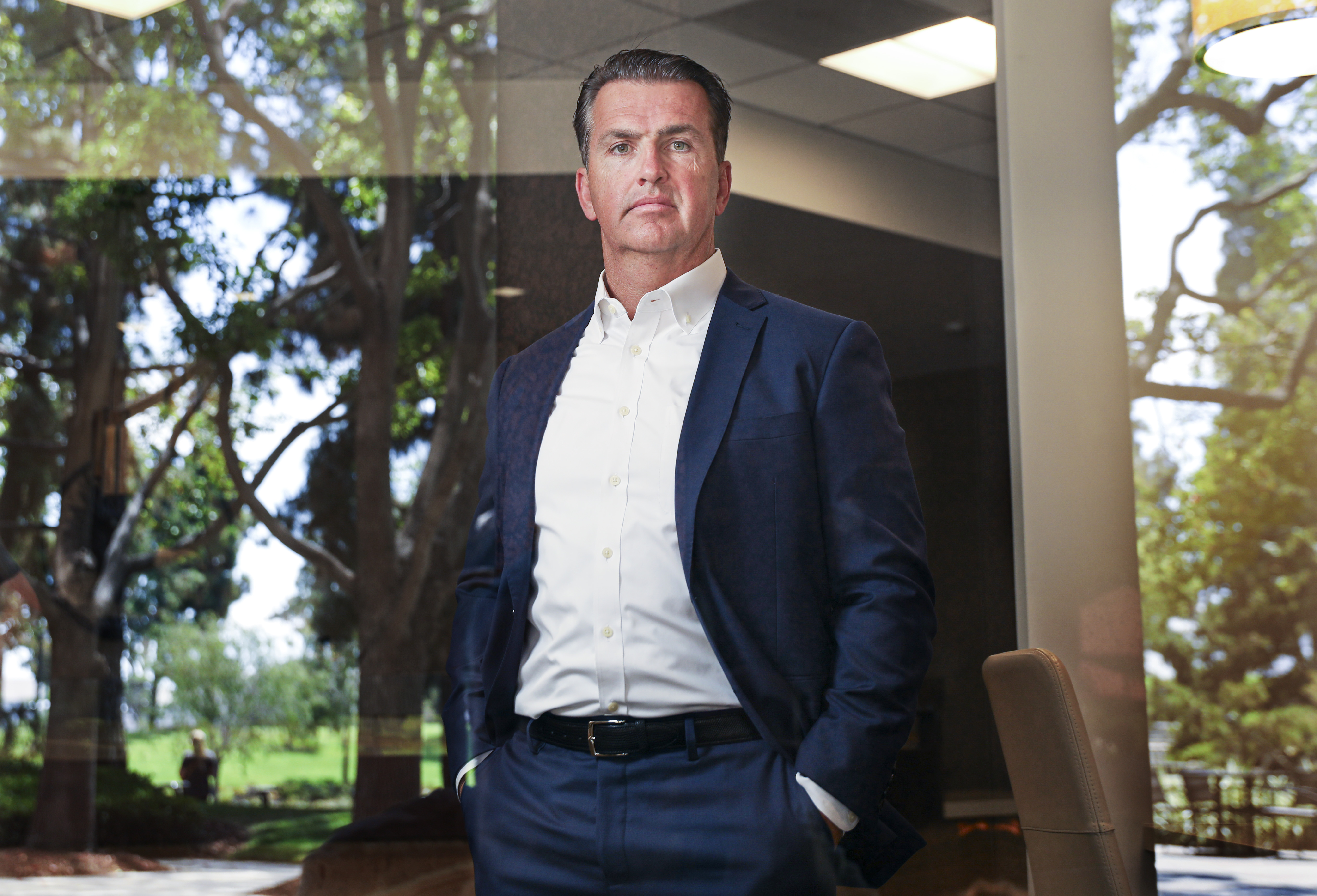 Axos chief executive Gregory Garrabrants standing in a San Diego office
