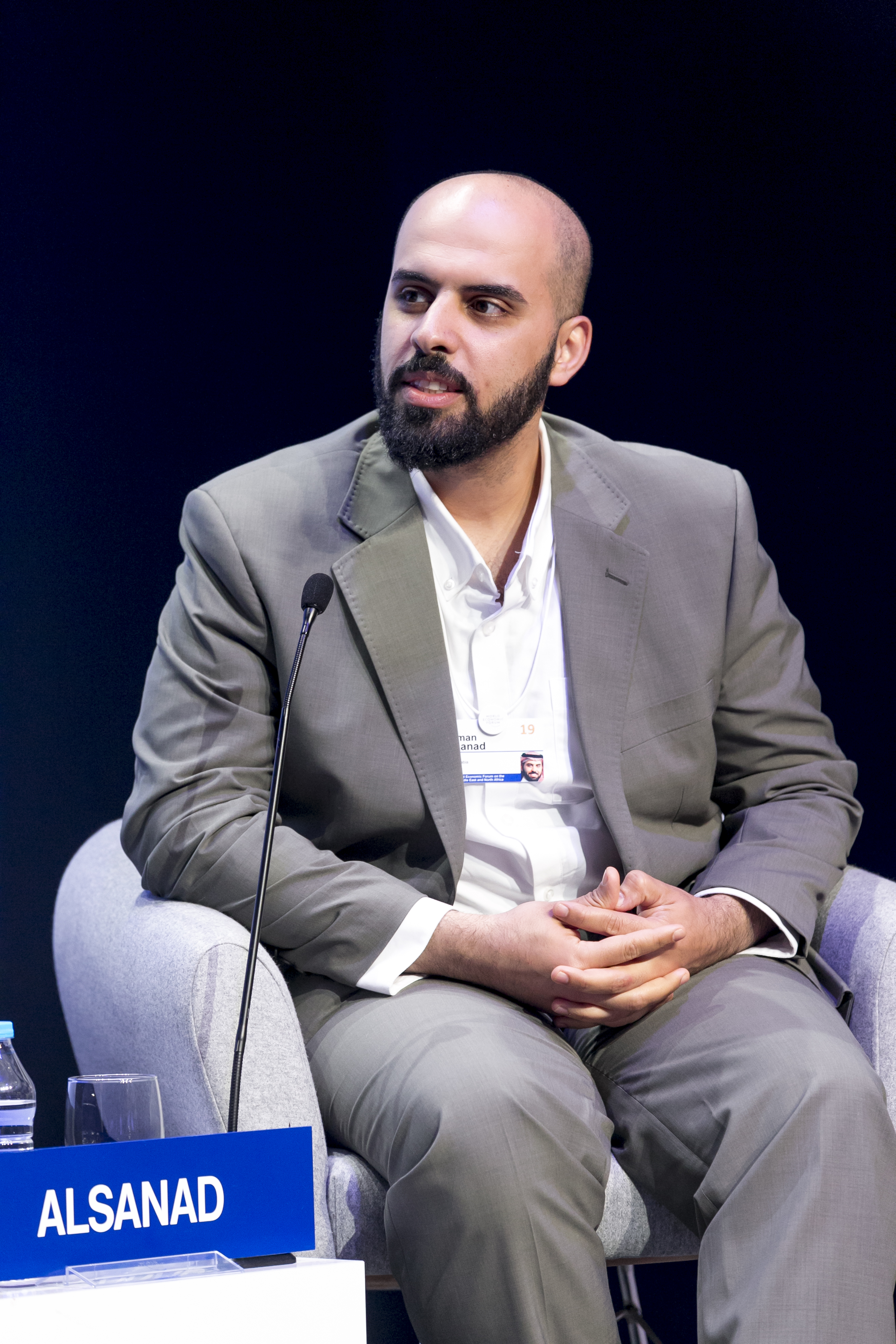 Ayman Alsanad seated beside a microphone during The Start-Up Revolution session at the World Economic Forum in Jordan in 2019.