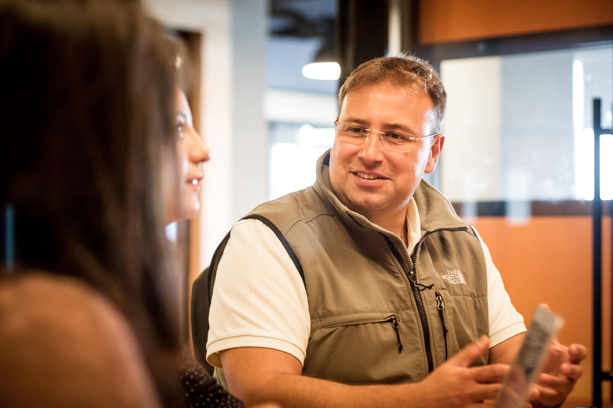 Aytekin Tank talking with another person at a table