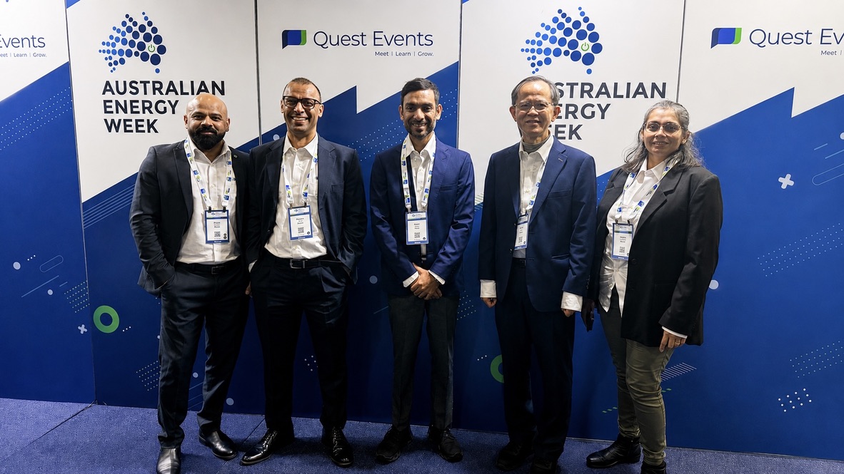 Ayush Sinhal at the centre of a group photograph at Australian Energy Week 2026