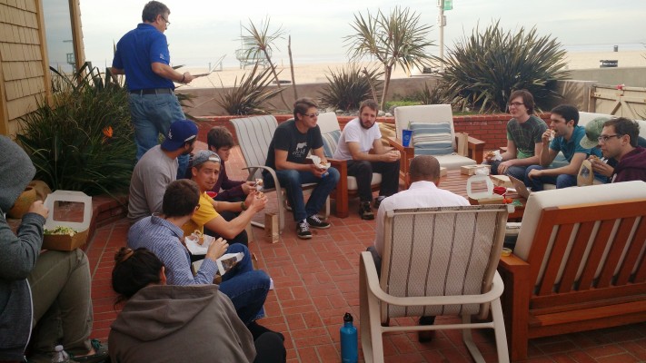 An early GoGuardian team gathering on a patio overlooking the beach