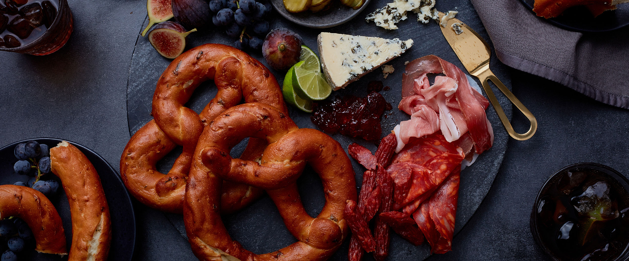 Bavarian soft pretzels arranged with cheese, fruit and charcuterie