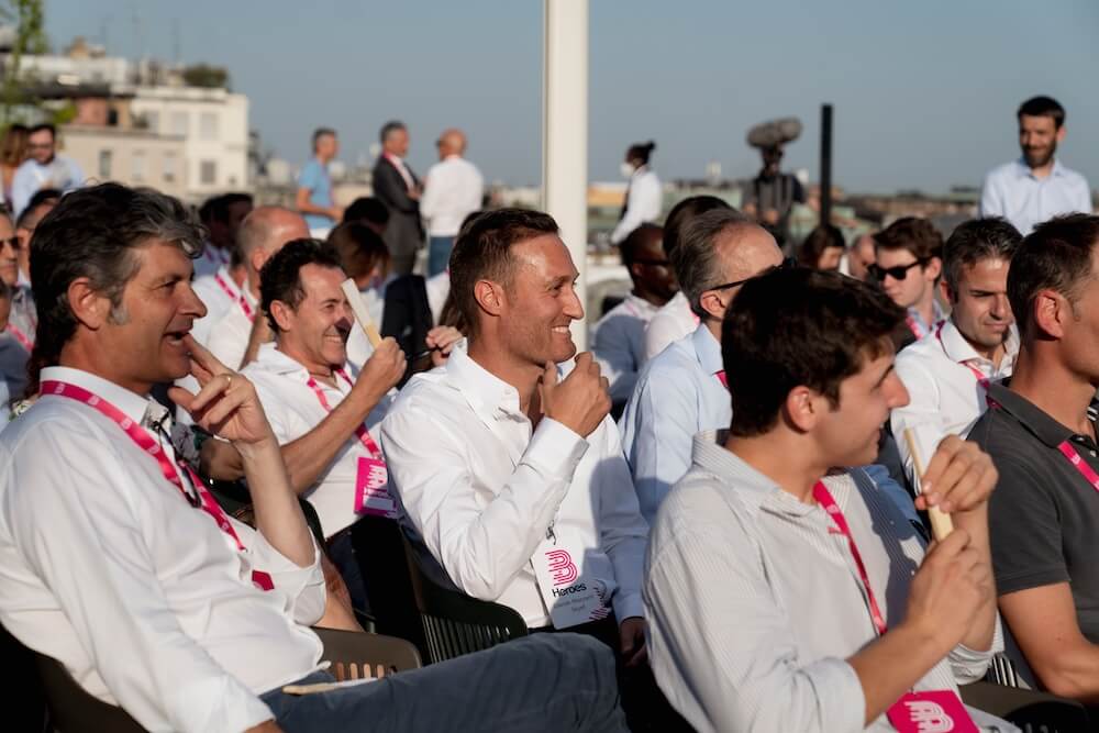 Attendees listening at an outdoor B Heroes community event