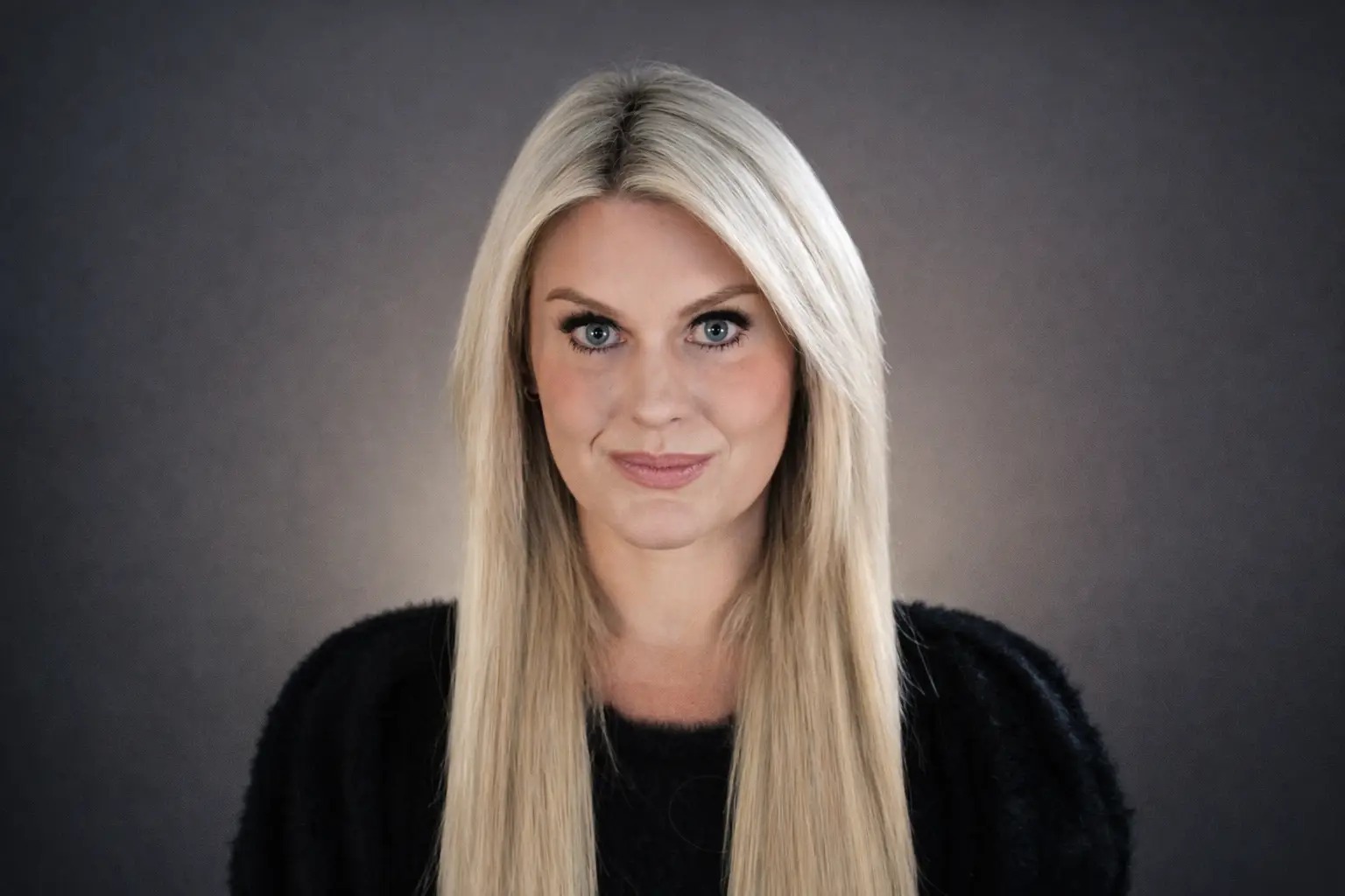Jordan Blakesley, co-founder and CEO of B Public Relations, against a gray studio background
