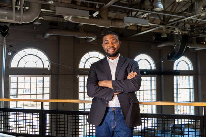 Babawande Afolabi standing in the Hansen Student Center at Illinois Wesleyan University