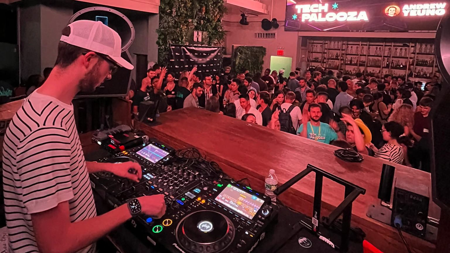Bailey Pumfleet at the DJ decks during Tech Palooza at Harbor NYC, facing the crowd