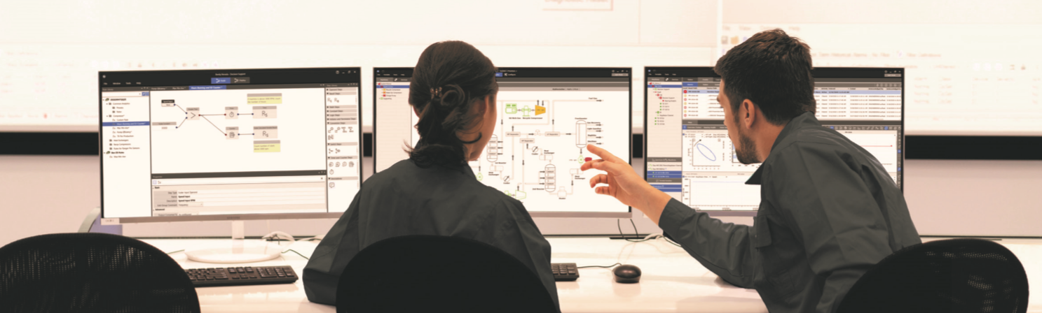 Bently Nevada monitoring staff examining machinery information across several workstation screens.