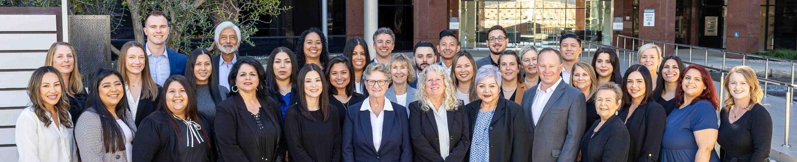 Bala Balkrishna, in the back row toward the left, with the Infinity Bank team outside their office