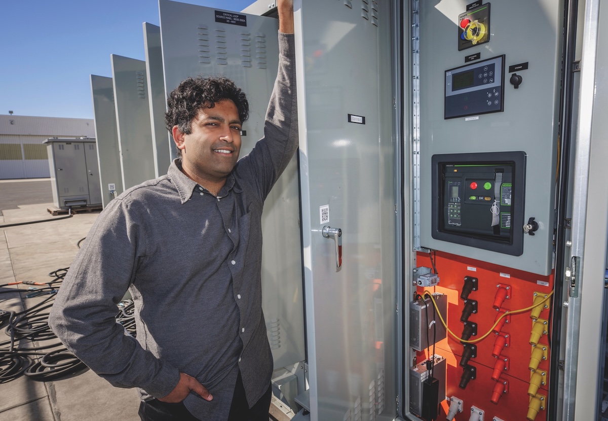 Bala Ramamurthy beside an open Critical Loop distribution control unit in Long Beach