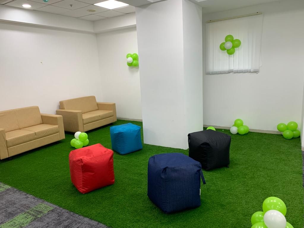 Securden’s new office lounge, with colorful seats and green and white balloons