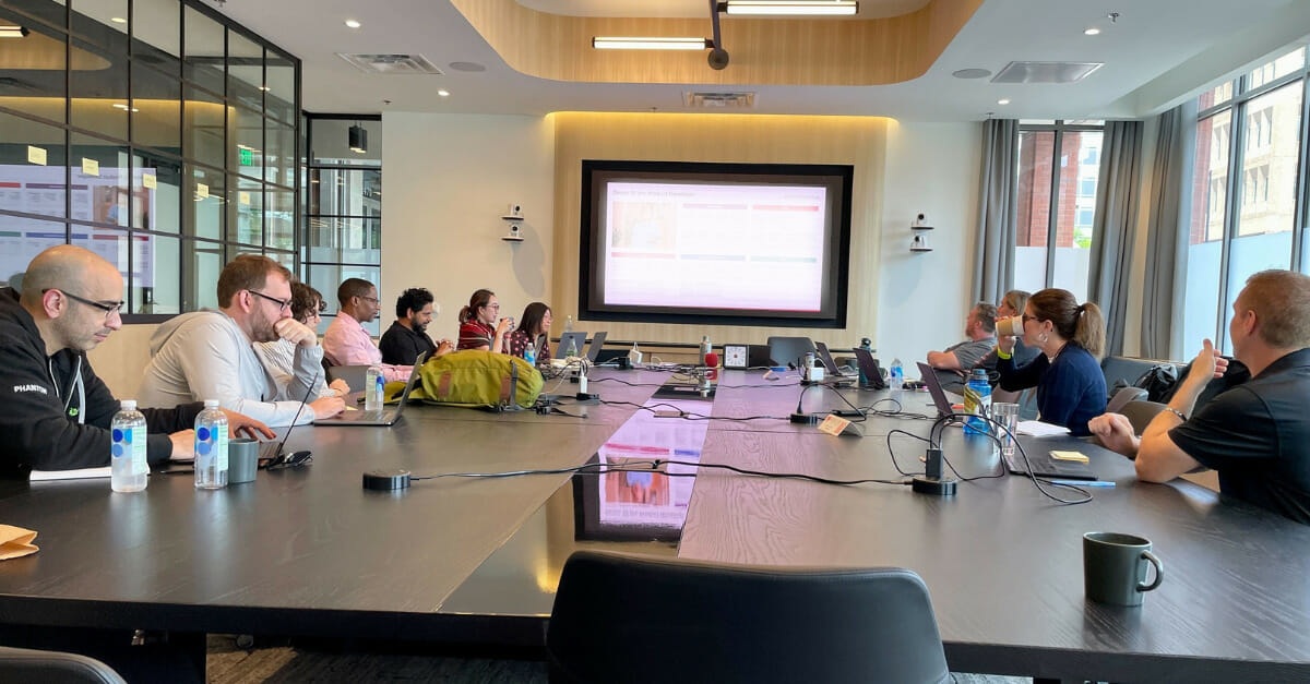 Bamboo Rose product team gathered around a meeting table in Boulder