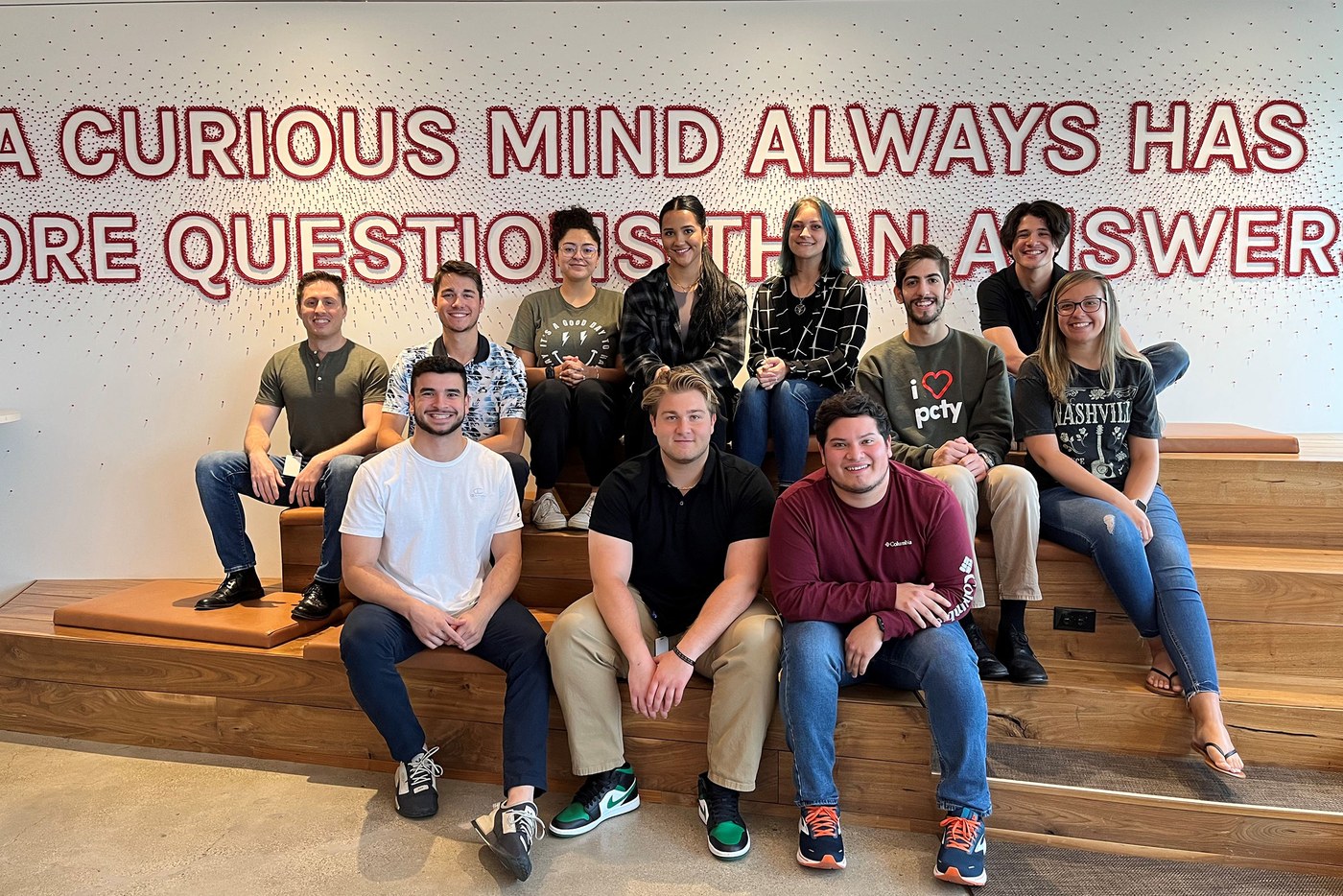 Paylocity employees seated together in a bright office collaboration area