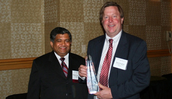 Bangalore Shivacharan and David Hughes holding TurningPoint's technology firm award