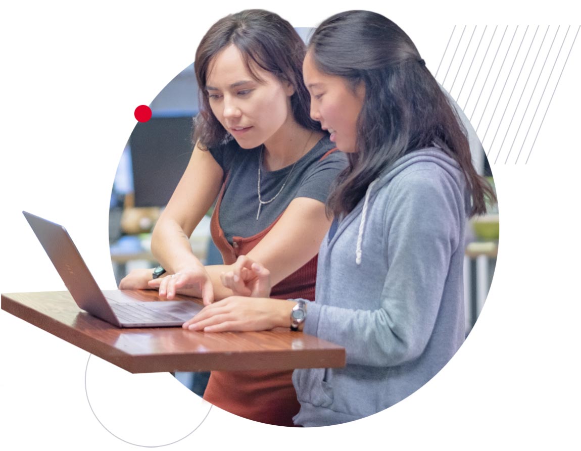 Two Industry Dive employees looking together at a laptop