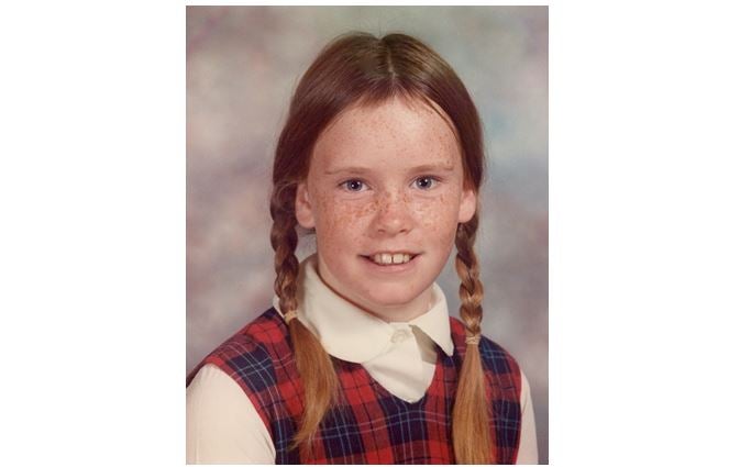 Barbara Fagan's fourth-grade school photograph, with braided hair and a plaid dress